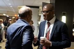 Attendees catch up with some coffee and a brief chat before heading into sessions.