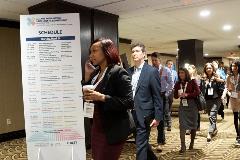 Attendees navigate to their tracks of choice during the meeting breakout sessions.
